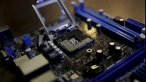 The motherboard of the computer is cleaned from dust with a brush