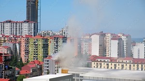 Smoke from the fire of residental building in the city. Emergency and disaster event within an urban setting. Timelapse