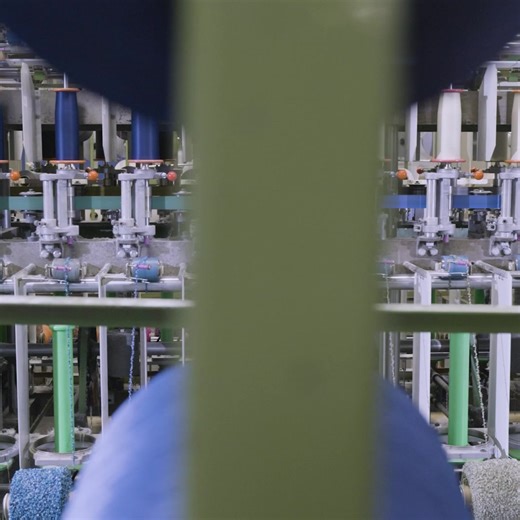 Yarn is being spun and woven into fabric for as far as the eye can...