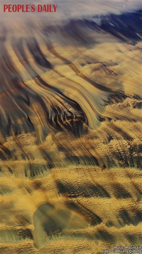 Massive quicksand patterns emerge as the Qiantang River tide recedes, glowing under the setting sun in a breathtaking display in Hangzhou, east China's Zhejiang Province. | People's Daily, China