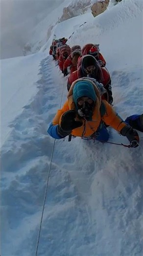 Climbers Conquer a Snowy Summit with Stunning Views