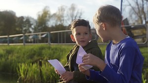 Kids sitting near the grass Free Stock Video Footage