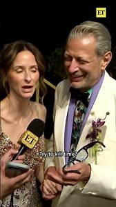 Jeff Goldblum reacts to getting caught looking at his own red carpet photos. (Carlos Barria/Reuters)