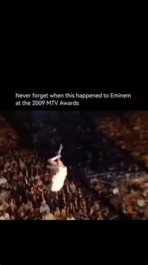Celeb source TV on Instagram: "Eminem’s 2009 MTV moment became instantly iconic when a stunt involving Sacha Baron Cohen’s Bruno character appeared to go disastrously wrong live on stage. During the ceremony, Bruno descended from the ceiling and seemingly crashed onto Eminem, his bare backside landing squarely in the rapper’s face. Eminem reacted by angrily storming out with his entourage, leaving the audience stunned. The incident was later revealed to be staged, but in the moment it perfectly