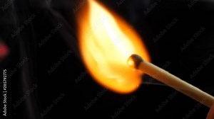 Close up of hands lighting a match. The wooden match is lighted from a box. Stock Video