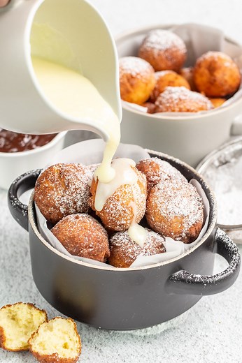 Soft and fluffy donut balls made with ricotta cheese and dusted with powdered sugar – the Ponchiki are indeed a taste of heaven! https://valentinascorner.com/donut-holes/ | Valentina's Corner