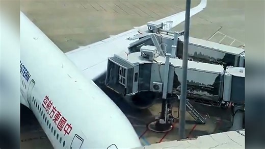 Airplane crashes into jet bridge