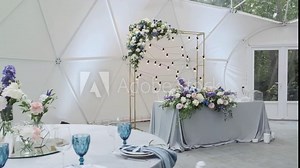 Banquet hall with laid tables in a round tent