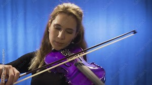Young musician woman playing violin on stage. Opera singer, composer. Young musician woman playing the violin on the stage of opera or music hall. Music that soothes the soul.