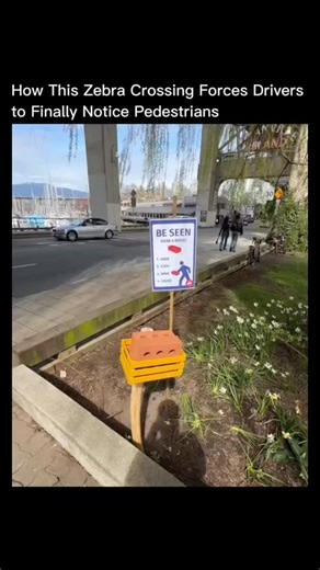 Innowired on Instagram: "It may look like a random brick on a crosswalk, but this is a smart pedestrian safety design called a "Be Seen" crossing. The brick is fake – made of foam or plastic – and pedestrians pick it up as they walk across. Drivers perceive it as a solid obstacle, instinctively slowing down or stopping. The crossing transforms the pedestrian into a moving warning sign, improving visibility and safety without lights or speed bumps. Trials in Europe, China, and Canada have shown h