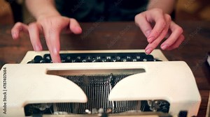detailed shot of a woman hands composing on a classic typewriter. Retro workplace ambiance, a secretary crafting a document. A young poet or author typing on an old-fashioned device.