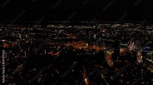 Night time aerial footage of the Leeds City Centre taken at night with a drone showing the West Yorkshire city centre all lit up with lights in the evening.