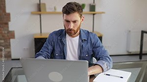 Shocked frustrated businessman, student feeling stressed, looking at computer screen, worried about a problem, reading bad online news, getting failed exam results