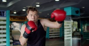 Boxing, man fighter trains his punches, training day in the boxing gym.