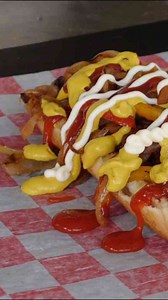 Preparing a Sonoran hot dog like a street food favorite