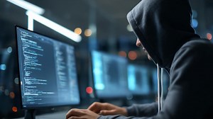 A Focused Programmer in a Dark Room: Diving Deep into Code with Multiple Monitors Illuminated by Screen Light and Reflecting Intense Concentration | Premium Stock Video Footage