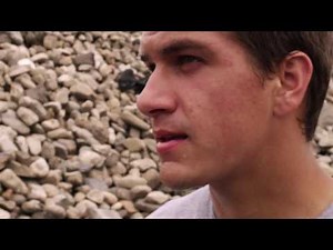 Close-up clip of sweat dripping off a young man's face.