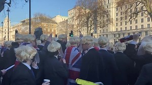Hundreds of bewigged Boris lookalikes protest partygate outside Downing Street