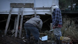 Gary Muehlberger and Curly Leach work together to gather wood to help fix Gary's house. | Life Below Zero
