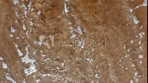 Sea waves ebb and flow over a mixed beach, viewed from above—perfect for holiday backgrounds or as a dynamic element in presentations.