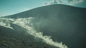 Rocky volcano while the smoke covers it - Free Stock Video