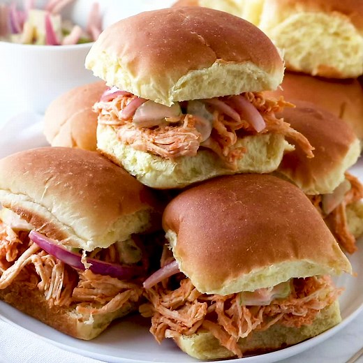 These Crock Pot Buffalo Chicken Sliders with Ranch Celery Slaw are the best! So much flavor and easy to serve. The perfect game day recipe! Recipe: https://www.thecountrycook.net/crock-pot-buffalo-chicken-sliders/ | The Country Cook
