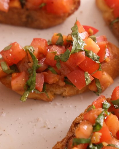Easy tomato Bruschetta is a wonderful Italian summertime appetizer! Simply stir together a garlicky marinated tomato topping with basil and balsamic vinegar and spoon it onto crunchy toasted bread. It’s that simple! | Preppy Kitchen