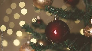Merry Christmas and happy New Year background. Close up of christmas tree branch with balls and festive sparkling lights on christmas background, copy space.