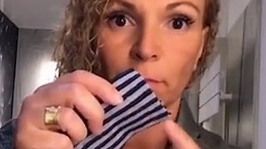 Belgian woman shows how to make a DIY face mask out of a sock
