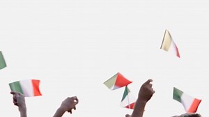 Hands waving with Italian flags outdoors.