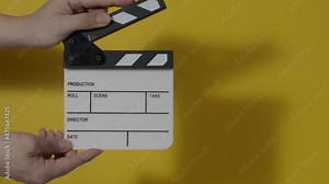Clapper board. Close up hand and film making clapperboard isolated on background studio. Movie or video production concept. Clappers board Shuts. Film crew holds film slate in hand for video recording