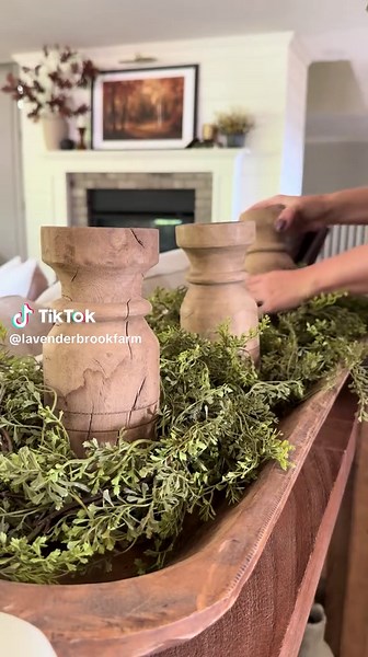 A long tray makes the perfect base for a layered fall centerpiece. 🍂 I started with a vine garland for movement, then added three vintage-style wood pillar candle holders with rechargeable candles for that cozy glow. From there, I tucked in fall-inspired hydrangea heads, dried gourds, and lotus pods to bring in texture and natural charm. The result is a timeless double-bowl centerpiece that feels collected, warm, and perfectly autumn. ✨ For links to items in this post, go to the links in my bio