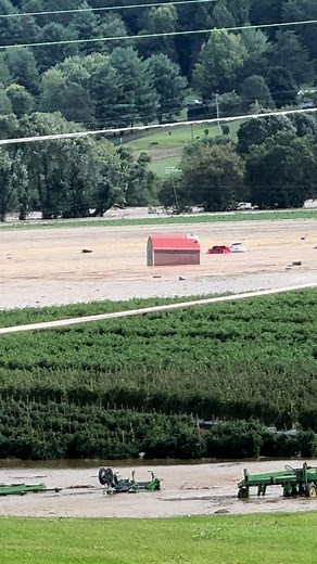 Jonesborough TN houses and cars being swept theough tomato fields from the Nolichucky River