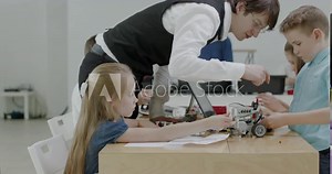 Curious kids working on a functional programable robot during robotics class at school. 4K UHD 60 FPS SLOW MOTION