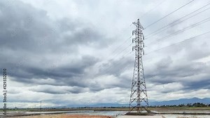 Timelapse of epic cloud movement, the cloud is moving very fast exactly in the top of the huge powerlines, transmission tower, pylon, or electrict tower.
