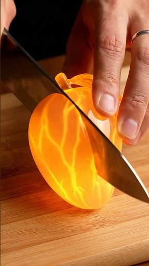 Highly realistic ultra 8K ASMR video of a human hand slicing a hyper detailed glowing glass mango