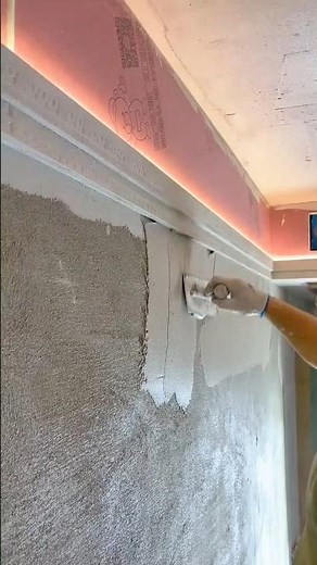 Interior Plastering: Worker Using a Trowel to Apply a Smooth Skim Coat to a Wall