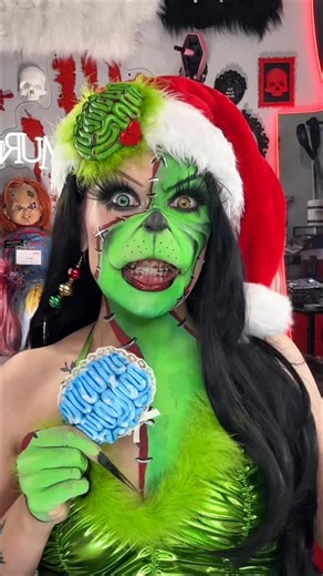 Theresa Spencer on Instagram: "Zombie Grinch deciding what 🧠 to wear!! WHICH IS UR FAVORITE 🔪💚💖🩵 I made the brain clips myself and I had to show you guys cause I’m so proud!! #grinchmakeup #thegrinch #zombiemakeup #sfxmakeup #christmasmakeup #polymerclay #brain #claycreations #creativemakeup"