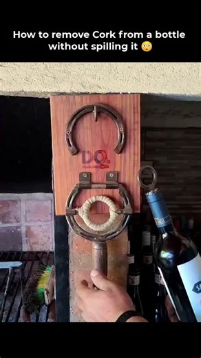 Meta Minutes on Instagram: "This ancient corkscrew design features a handle with a ring mechanism that hooks onto a nail or peg on a pillar, allowing smooth downward movement to pull out the cork. Unlike modern handheld versions, this tool uses leverage and steady pressure to remove the cork effortlessly, preventing spills or breakage. It was a clever invention that made opening bottles of wine or beer both easy and elegant, showcasing early human ingenuity in creating practical mechanical aids 