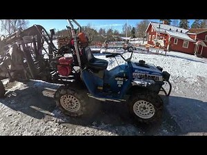 Mini forwarder and ATV moving logs to sawmill