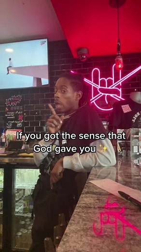 Bar Scene with Neon Art and Unique Hand Gestures