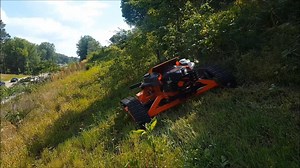 Using proven design elements of the popular TRX-44-PRO, the TRX-48-PRO slope mower is the new king of the hill here at Remote Mowers. The new track system is much longer taking ground pressure down to 30-40 lbs for each heavy duty roller. This keeps the tracks firmly planted on the ground at all times giving you loads of traction for hanging on to 50° slopes without using aggressive tread patterns that dig up the soil. Using the same unstoppable design as before, the front and rear main rollers 