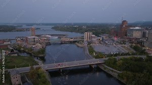 Drone shot of the Ottawa River in Ottawa Canada at sunrise, showing Chaudiere Falls, Chaudiere Island and many bridges connecting Ottawa to Gatineau