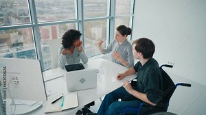 Teamwork of successful diversity multi ethnic people in modern office, man in wheelchair with disability. Hold hands together support decision, unity gesture. Cooperation mutual help at work concept.