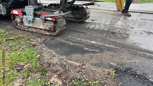 A Cold Milling Machines Rips up Comcrete or Pavement of old Road for Repaving - V2