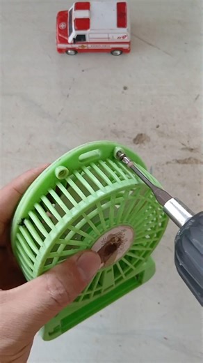 Reassemble the broken mini fan parts after repair.