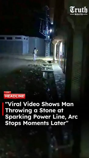 Truth Route News on Instagram: "A video circulating on social media shows an electrical transformer or power line producing visible blue sparks, indicating an electrical arc. During the incident, a man is seen throwing a stone toward the sparking area. Shortly after the stone makes contact, the visible arcing appears to stop in the clip. The video does not confirm whether the stone caused the change or if the interruption occurred due to an automatic electrical safety mechanism. The exact locati