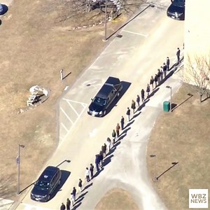 Mourners outside Saint Thomas Aquinas High School in Dover, New Hampshire pay their respects as the procession for Marine Capt. Jack Casey passes by. Casey was one of five Marines killed in a California helicopter crash earlier this month. | WBZ / CBS News Boston