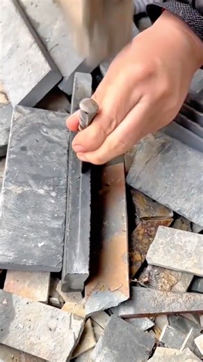 Worker Chiseling Slate Stone Tiles Using Sharp Mason Chisel