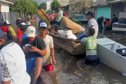 Residents in northern Colombia scramble to recover belongings after flooding